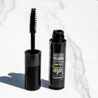 A tube of Natural & Organic Black Mascara stands open on white marble, its wand upright. The label reads “100% natural, gluten-free, vegan.” “BEST SELLER” is displayed in the top left corner.