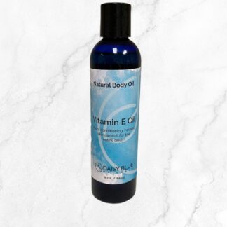 A blue bottle of Vitamin E Body Oil stands on a white marble background, with its label emphasizing skin conditioning. "Best Seller" appears in black text at the top left corner.