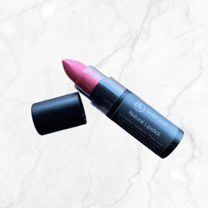 Flawless Glow Blush rests on a light marble surface next to its matching pink lipstick, both uncapped and creating a chic, radiant beauty pair.
