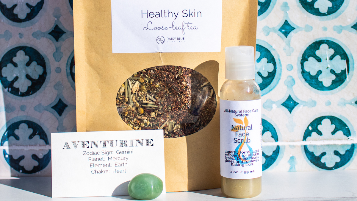This image features one piece of Daisy Blue March News—the Spring Abundance Trio. It includes the Green Aventurine Stone, Healthy Skin Loose-Leaf Tea and Natural Facial Scrub.