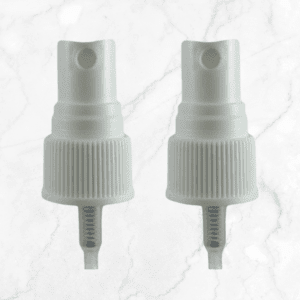 Two white Spray Mist Pump nozzles with ribbed collars and clear dip tubes are placed side by side on a light marble surface.