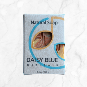 A rectangular box of Bohemian Body Bar Soap sits on a white marble surface. The gray box has blue and tan accents, with a cutout displaying the soap. The label reads "4.5 oz/128 g.
